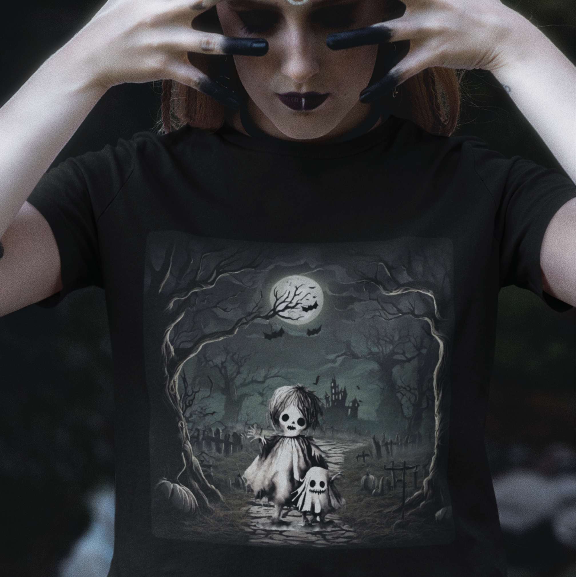 Person wearing a black t-shirt with a gothic design of a doll and ghost in a cemetery.