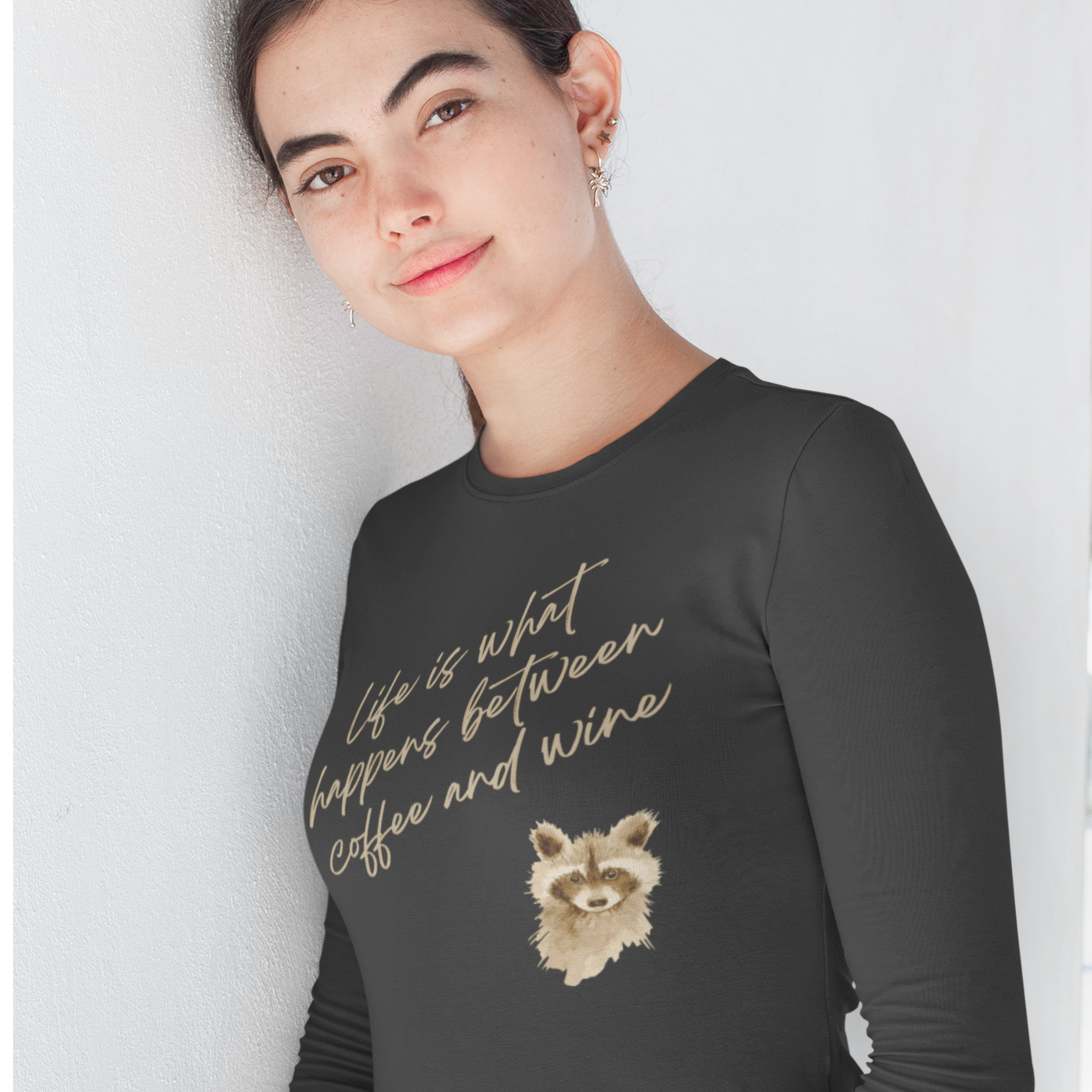 Person wearing a black long-sleeve shirt with a graphic and text against a white background