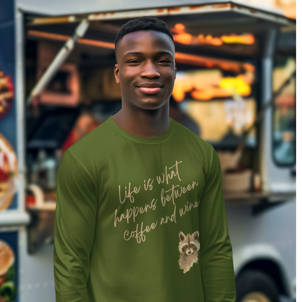 Man wearing a green shirt with a quote and raccoon graphic in front of a food truck.