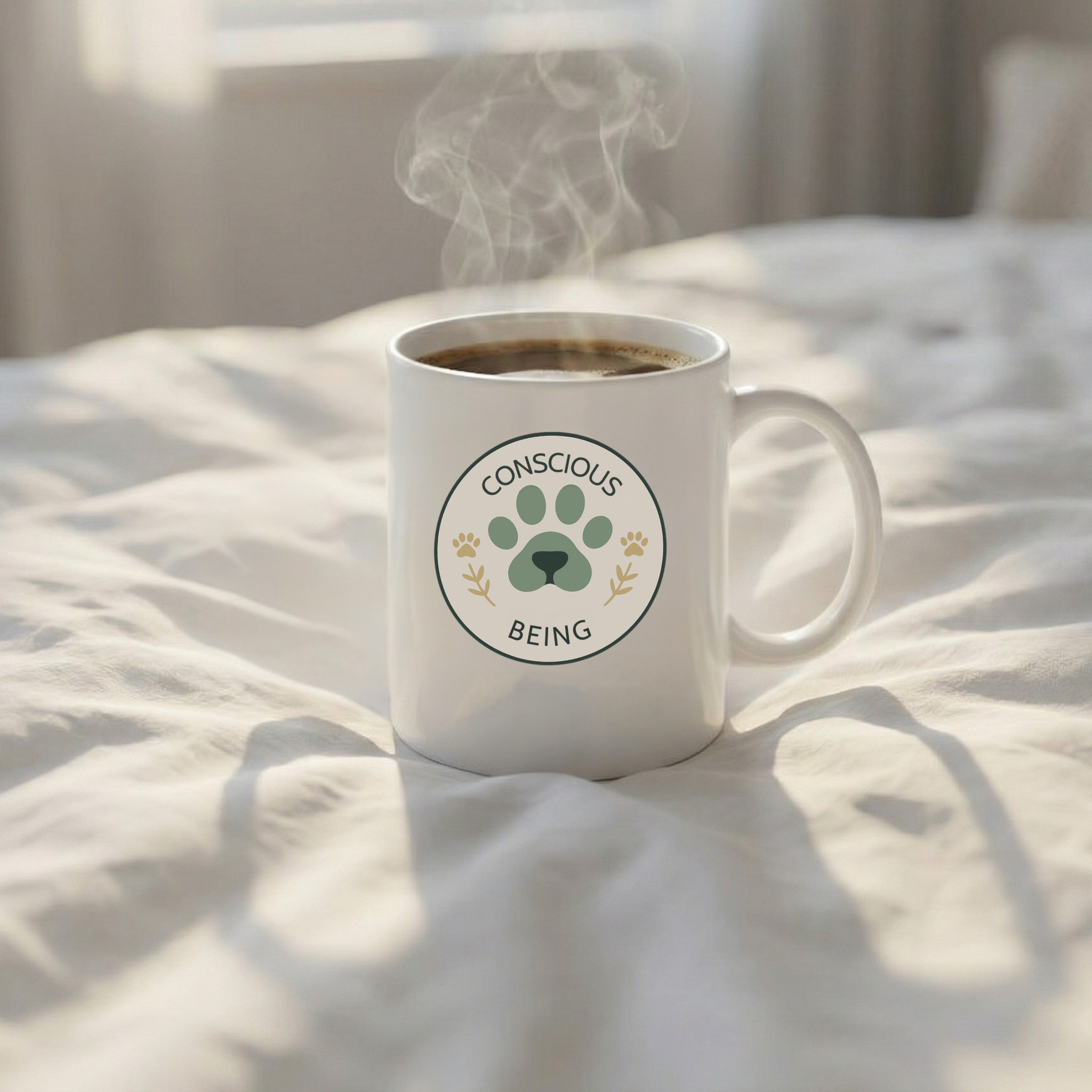 White mug with 'Conscious Being' logo on a bed with steam rising from it
