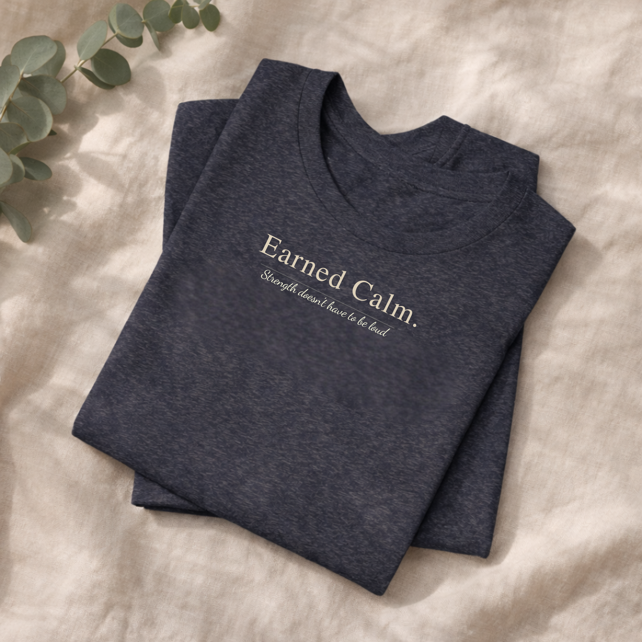 Earned Calm minimalist t-shirt featuring a quiet strength quote. Soft, modern unisex tee designed for calm confidence and everyday wear.